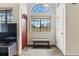 Welcoming foyer with high ceilings, slate flooring, bench seating, and large windows to outside at 3105 Galileo Ln, Boulder, CO 80301