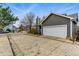 Exterior view of the home featuring a two-car garage and gray siding at 3105 Galileo Ln, Boulder, CO 80301