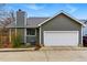 Exterior view of the home featuring a two-car garage and gray siding at 3105 Galileo Ln, Boulder, CO 80301