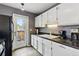 Kitchen area with white cabinets, stainless steel appliances, and a door leading to the backyard at 3105 Galileo Ln, Boulder, CO 80301