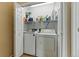 A practical laundry room features a washer, dryer and shelving for organized storage at 3105 Galileo Ln, Boulder, CO 80301