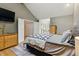 Inviting bedroom area featuring nice decor, wood floors, and a glimpse into the ensuite bathroom at 3105 Galileo Ln, Boulder, CO 80301