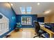 Bright office space with blue walls, a skylight, a window with a view, and a desk and chair at 3105 Galileo Ln, Boulder, CO 80301