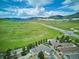 Stunning aerial view showcasing the property's location with sprawling green fields and mountain views at 5603 Van Bibber Ct, Golden, CO 80403