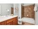 Bathroom featuring a wooden vanity, tiled floors and shower with shower and bath at 5603 Van Bibber Ct, Golden, CO 80403