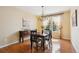 Cozy dining room featuring hardwood floors, chandelier lighting, and natural light from the windows at 5603 Van Bibber Ct, Golden, CO 80403