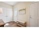 Foyer with tiled floors, a wood table, painting, bench, and plenty of natural light from the front door at 5603 Van Bibber Ct, Golden, CO 80403