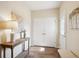 Foyer features tiled floors, a wooden table with a lamp, and white trim at 5603 Van Bibber Ct, Golden, CO 80403