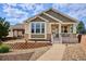 Charming single-Gathering home with manicured landscaping, stone accents, and welcoming front porch at 5603 Van Bibber Ct, Golden, CO 80403