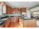 Bright kitchen features wood cabinets, stainless appliances, granite countertops and an island at 5603 Van Bibber Ct, Golden, CO 80403