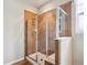 Modern tiled glass-enclosed shower with bench, and a window for natural light at 5603 Van Bibber Ct, Golden, CO 80403