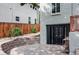 Basement entry featuring new black glass doors, a seating area, and stone retaining wall at 2895 S Sherman St, Englewood, CO 80113