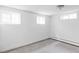 Finished basement featuring bright white walls and three windows allowing natural light at 2895 S Sherman St, Englewood, CO 80113