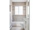 Clean bathroom featuring tiled walls, a tub-shower combo, and vanity storage at 2895 S Sherman St, Englewood, CO 80113
