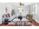 Bright living room featuring a comfortable sofa, stylish chairs, and a decorative rug at 2895 S Sherman St, Englewood, CO 80113