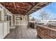 A covered patio area with wooden decking and outdoor seating, including a stone fireplace at 4650 E Links Pkwy, Centennial, CO 80122