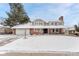 Charming brick home with a manicured lawn covered in fresh snow and a welcoming entrance at 4650 E Links Pkwy, Centennial, CO 80122