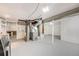 Unfinished basement with painted floor and utilities at 903 Poplar St, Denver, CO 80220