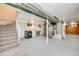 Unfinished basement with painted floor, stairs and laundry hookups at 903 Poplar St, Denver, CO 80220