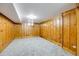 Finished basement features wood paneling and neutral carpeting at 903 Poplar St, Denver, CO 80220