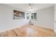 Bright, empty bedroom features hardwood floors, a ceiling fan, and a large window at 903 Poplar St, Denver, CO 80220