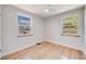 Clean bedroom featuring hardwood floors and two bright windows at 903 Poplar St, Denver, CO 80220