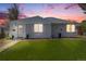 Charming single-story home with a well-manicured lawn and inviting front entrance at dusk at 903 Poplar St, Denver, CO 80220