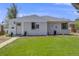 Charming single-story home with a well-manicured lawn and inviting front entrance at 903 Poplar St, Denver, CO 80220