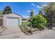 View of a detached garage and fenced yard of a home on a sunny day at 903 Poplar St, Denver, CO 80220