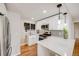Modern kitchen with white cabinets, stainless steel appliances, and sleek countertops at 903 Poplar St, Denver, CO 80220
