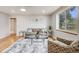 Bright living room featuring hardwood floors, neutral furnishings, and a large window at 903 Poplar St, Denver, CO 80220