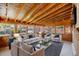 Sunroom-style living room with vaulted wood ceilings, lots of windows, and comfortable seating arrangements at 903 Poplar St, Denver, CO 80220