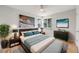 Comfortable primary bedroom features a plush bed, stylish furniture, and a corner window at 903 Poplar St, Denver, CO 80220
