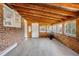 Charming sunroom with wood ceiling, brick accent wall, and lots of natural light at 903 Poplar St, Denver, CO 80220