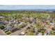 Aerial view of the neighborhood near a large park with mature trees and cityscape in the distance at 998 S Leyden St, Denver, CO 80224