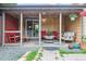 View of the covered back porch with chairs, tables, plants and a paved walkway at 998 S Leyden St, Denver, CO 80224