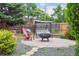 The backyard is a peaceful retreat with a brick patio, swing, and inviting seating around a fire pit at 998 S Leyden St, Denver, CO 80224