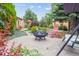 Beautiful backyard features a brick patio, fire pit, lush landscaping, and outdoor seating at 998 S Leyden St, Denver, CO 80224