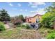 Backyard showcases a lush garden, patio furniture, and a charming outdoor space for relaxation at 998 S Leyden St, Denver, CO 80224