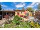 Spacious backyard featuring a wooden deck, outdoor dining area, lush garden and charming landscaping at 998 S Leyden St, Denver, CO 80224