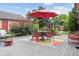The wooden patio is perfect for outdoor dining, and is beautifully decorated with a colorful outdoor rug at 998 S Leyden St, Denver, CO 80224