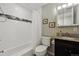 Bathroom with shower/tub combo and modern vanity at 998 S Leyden St, Denver, CO 80224