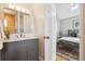 Bathroom with a gray vanity, marble countertop, and a view of the bedroom at 998 S Leyden St, Denver, CO 80224