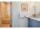 Updated bathroom features a glass enclosed shower with a built in bench at 998 S Leyden St, Denver, CO 80224
