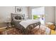 Cozy bedroom with neutral tones, a large window, and a sliding glass door to the outside deck at 998 S Leyden St, Denver, CO 80224