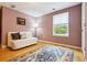 Bedroom with light-wood floors, a futon, and a large window at 998 S Leyden St, Denver, CO 80224