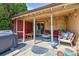 Cozy covered patio with outdoor seating, a grill, stylish decor and a brick accent wall at 998 S Leyden St, Denver, CO 80224