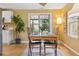 Dining room showcases a wooden table with seating for four, a sliding glass door to the patio, and hardwood floors at 998 S Leyden St, Denver, CO 80224