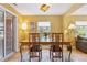 Dining room features a wooden table with seating for four, stylish lighting, and a view of the backyard at 998 S Leyden St, Denver, CO 80224
