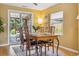 Dining area features a wooden table with seating for four, sliding glass doors to the backyard, and natural light at 998 S Leyden St, Denver, CO 80224